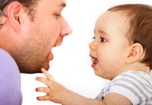Vater mit Baby beim Erforschen der Sprache
